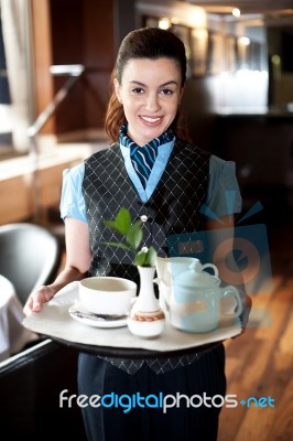 Maid Holding Tea Tray For Guest Stock Photo