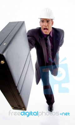 Male Architect Holding Office Bag In Running Posture Stock Photo