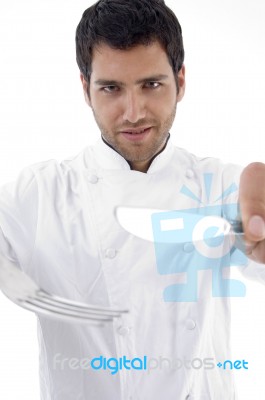 Male Chef Holding Cutlery Stock Photo