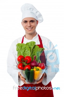 Male Chef Holding Glass Bowl Full Of Vegetables Stock Photo