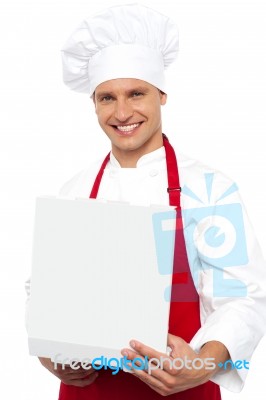 Male Chef Holding Pizza Box Stock Photo