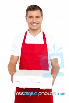 Male Chef Holding Pizza Box Stock Photo