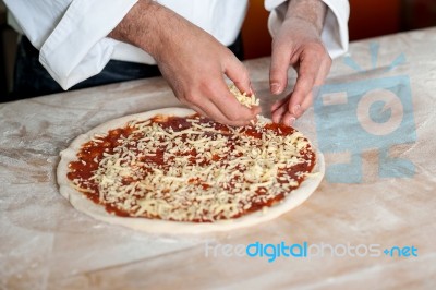 Male Chef Preparing Pizza, Closeup Shot Stock Photo