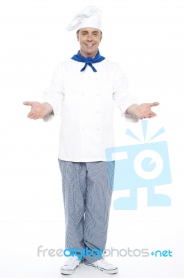 Male Chef Showing Welcome Gesture Stock Photo