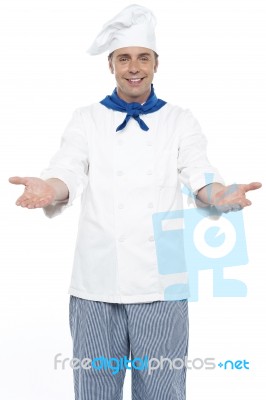 Male Chef Showing Welcome Gesture Stock Photo