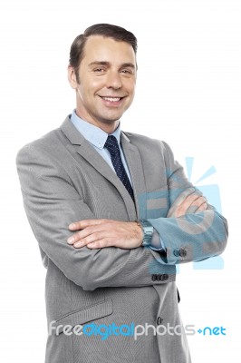 Male Consultant Smiling With His Arms Crossed Stock Photo