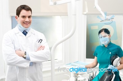 Male Dentist With Female Assistant Stock Photo