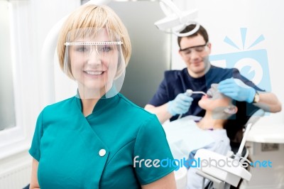 Male Dentist With Patient, In Clinic Stock Photo