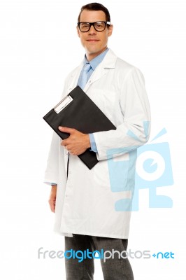 Male Doctor Holding Clipboard Stock Photo