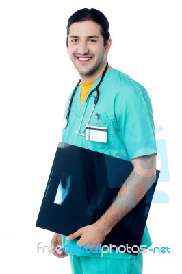 Male Doctor Holding Patient's X-ray Report Stock Photo