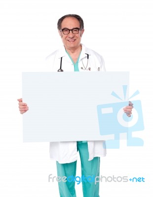 Male Doctor Holding White Board Stock Photo