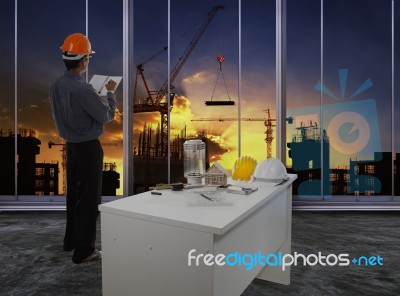 Male Engineer Checking Work Flow In Building Construction Site A… Stock Photo