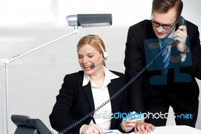 Male Executive Attending Clients Call Stock Photo