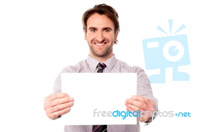 Male Executive Holding Out Blank Ad Board Stock Photo