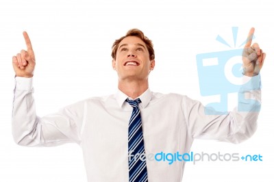 Male Executive Looking And Pointing Upwards Stock Photo