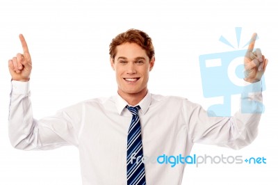 Male Executive Pointing Upwards Stock Photo