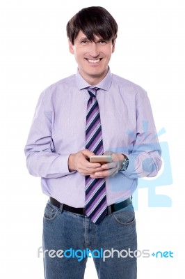 Male Executive Sending  Sms With His Phone Stock Photo