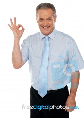 Male Executive Showing Okay Sign Stock Photo