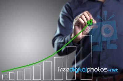 Male Hand Drawing A Chart Stock Photo