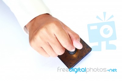 Male Hand Holding Rubber Stamp Stock Photo