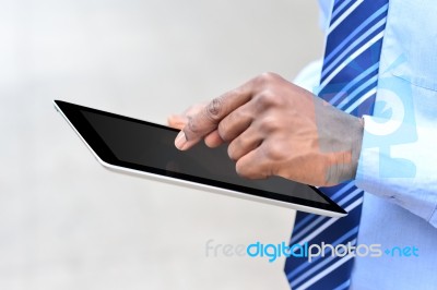 Male Hand Operating Digital Tablet Stock Photo