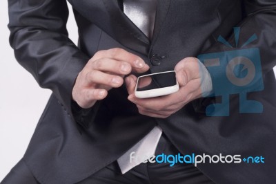 Male Hand Reviewing Information On Smart Phone Stock Photo