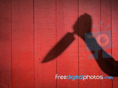 Male Hand Shadow With Knife Stock Photo