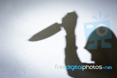 Male Hand Shadow With Knife Stock Photo