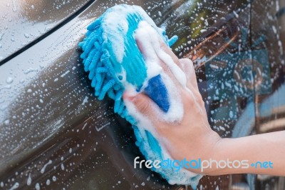 Male Hand Washing Brown Car With Blue Sponge And Bubbles (foam) Stock Photo