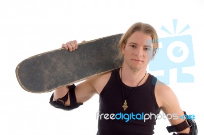 Male Holding Skateboard On Shoulder Stock Photo