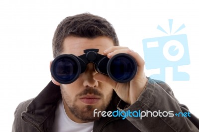 Male looking through binoculars Stock Photo