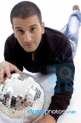 Male Lying With Disco Ball Stock Photo