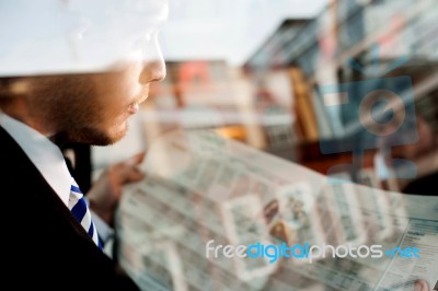 Male Passenger Reading Newspaper In Taxi Stock Photo