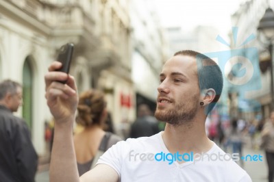 male Photographer With Mobile Phone Stock Photo