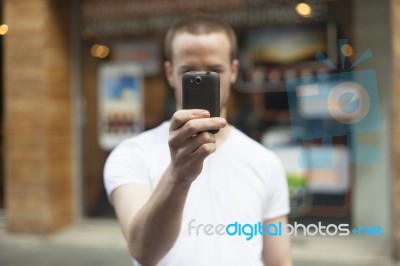 male Photographer With Mobile Phone Stock Photo