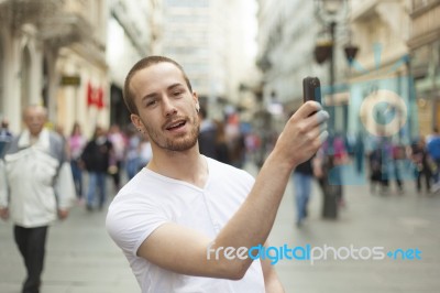 male Photographer With Smartphone Stock Photo