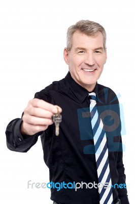 Male Realtor Showing The Keys To Camera Stock Photo