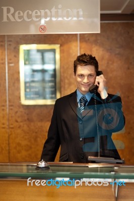 Male Receptionist Talking Phone Stock Photo