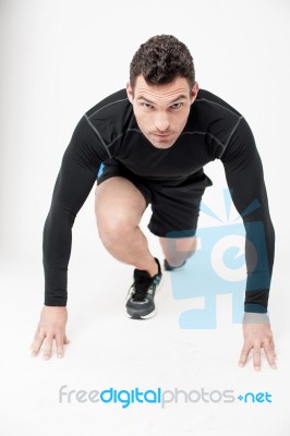 Male Runner In Starting Position Stock Photo