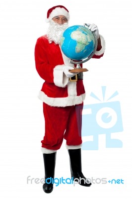 Male Santa Holding A Globe Map Stock Photo