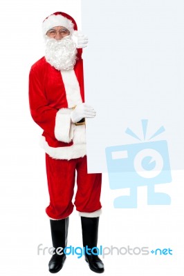 Male Santa Holding Whiteboard Stock Photo