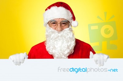 Male Santa Standing Behind Big Blank Banner Ad Board Stock Photo