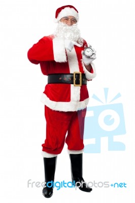 Male Santa With Alarm Clock, Studio Shot Stock Photo