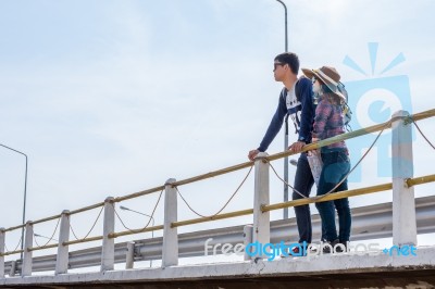 Male Tourists Enjoy The Bridge Stock Photo