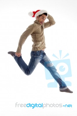 Male Wearing Santa Hat And Jumping Stock Photo