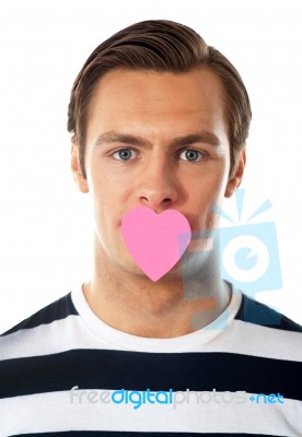 Male With Paper Heart On Mouth Stock Photo