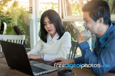 Man And Woman Workers Talking In Coffee Shop Stock Photo