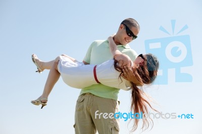 Man Carrying His Girlfriend Stock Photo