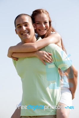 Man Carrying Woman On Back Stock Photo