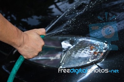 Man Cleaning Car With Water Stock Photo